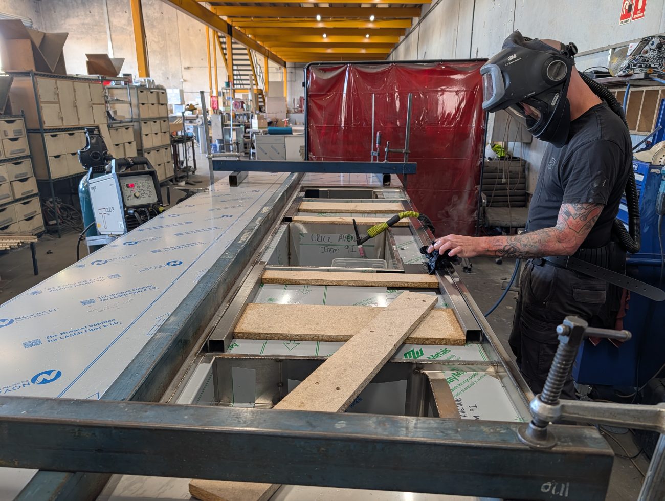 Triple X craftsman fabricating stainless in the workshop