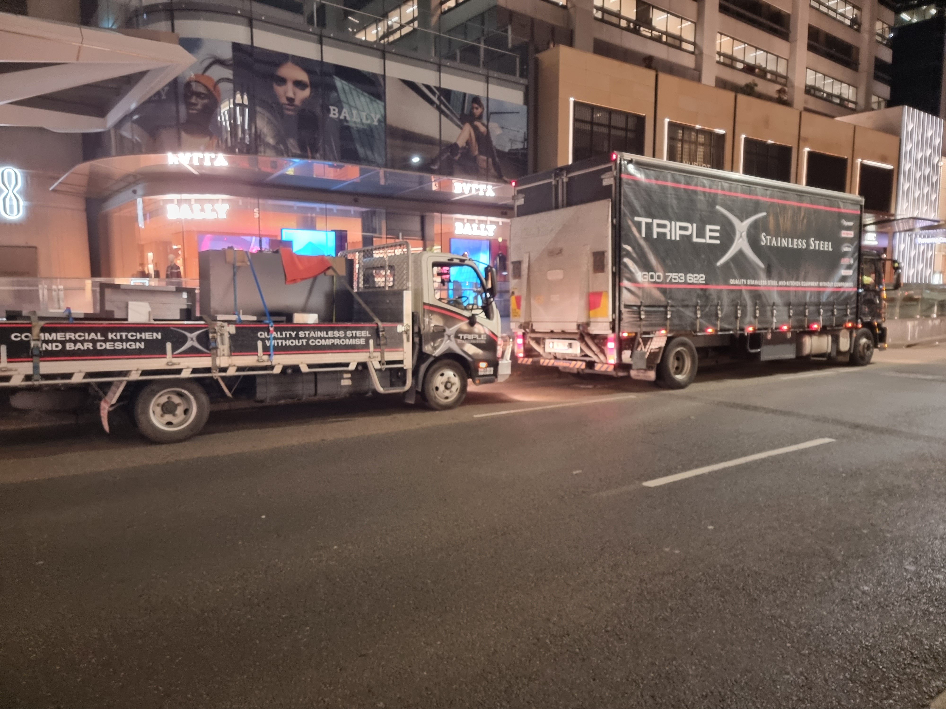 Triple X Stainless Steel delivery trucks loaded with fabricated stainless outside a Sydney city job